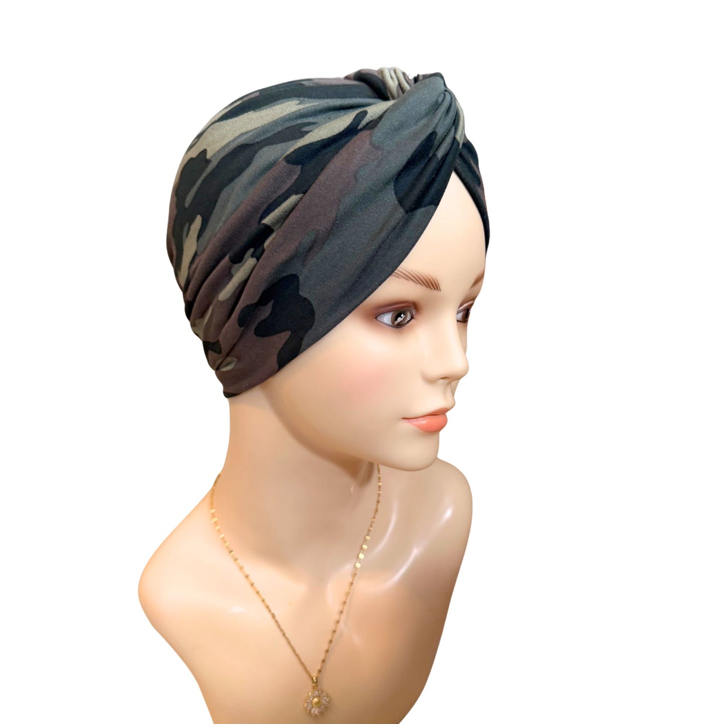 Camouflage-patterned headscarf on a mannequin head against a white background