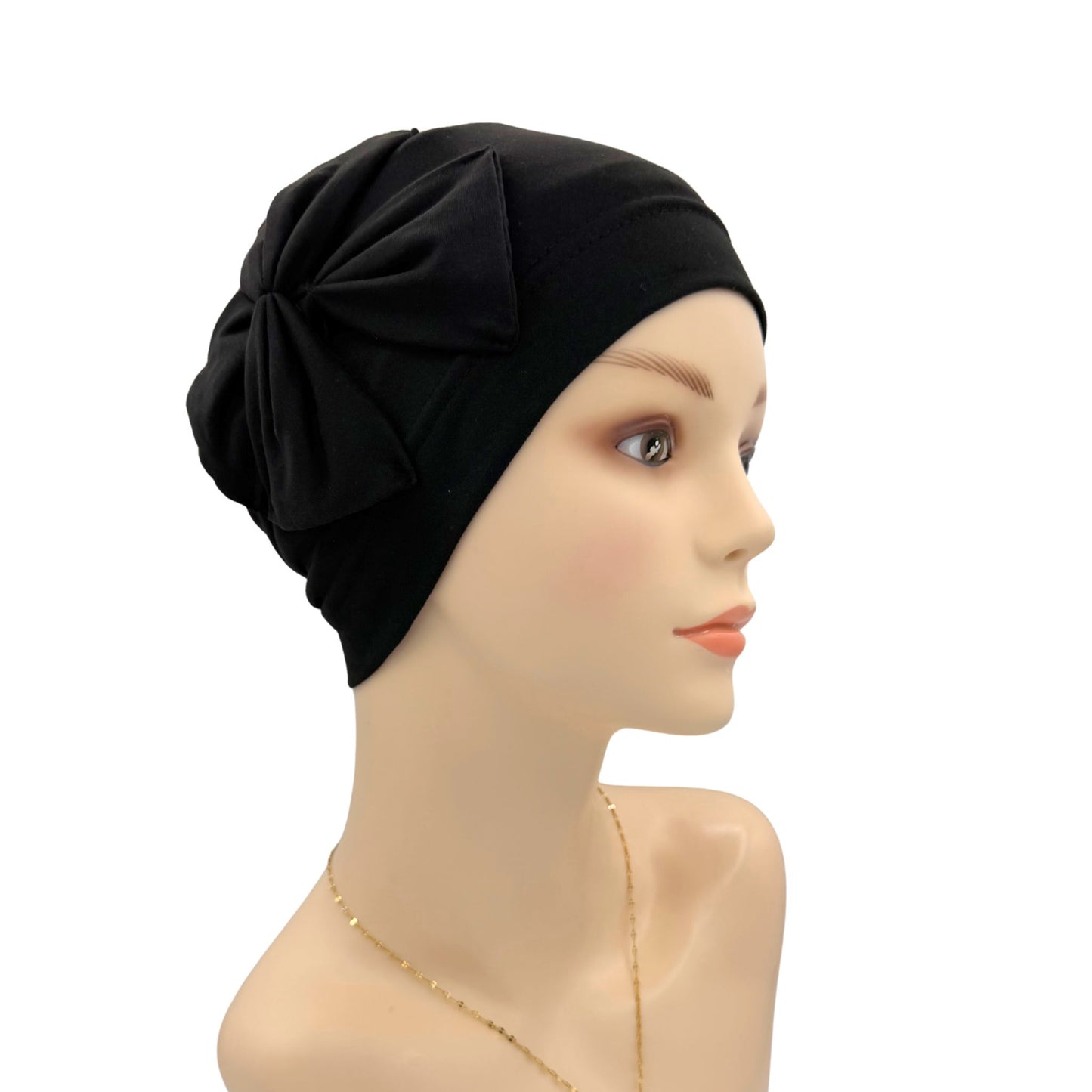 Black headscarf with a knot on a mannequin head against a white background