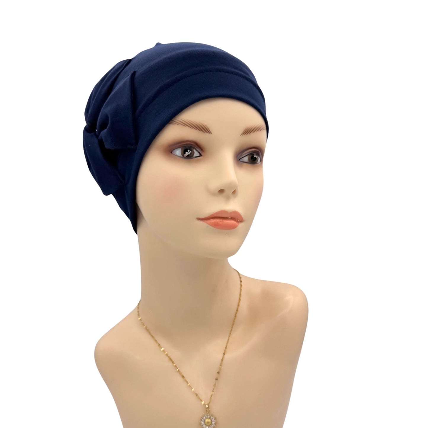 Navy blue headscarf on a mannequin head with a white background