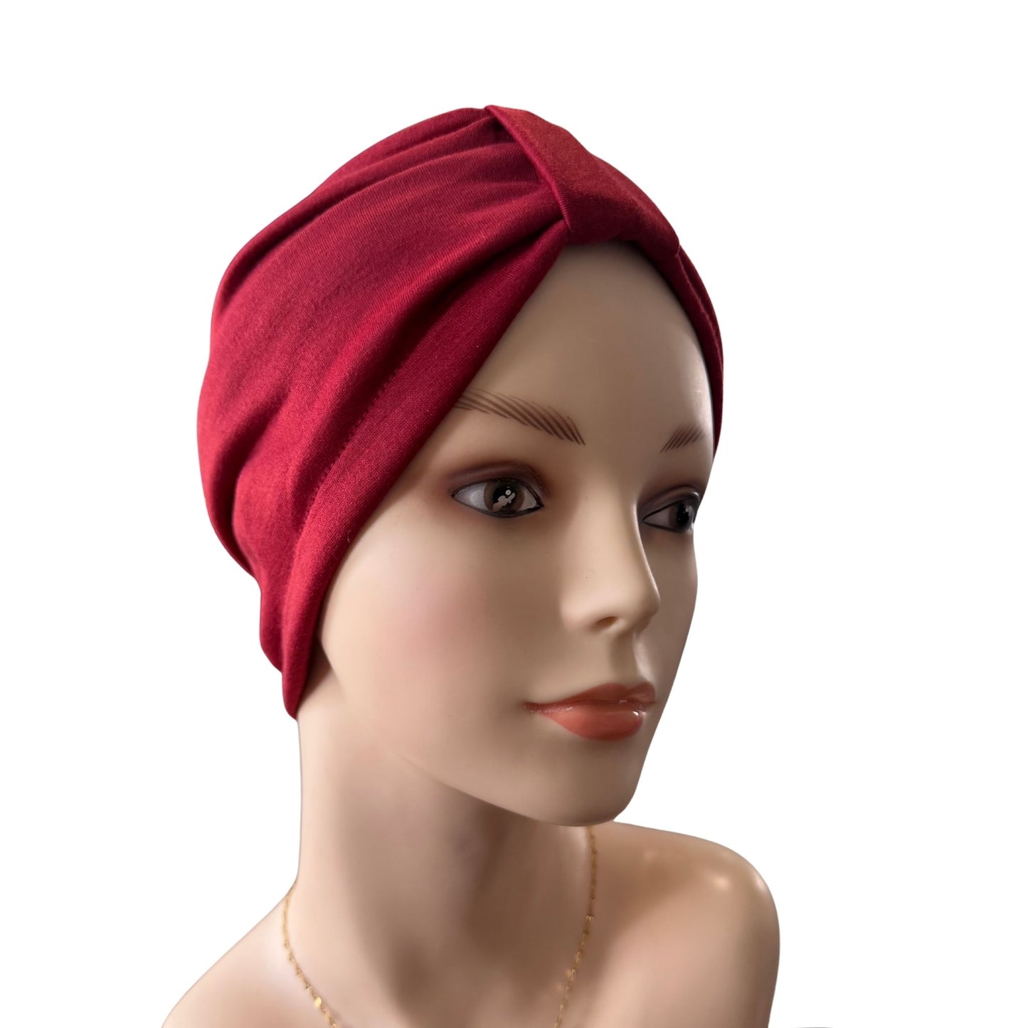 A deep red twisted turban-style head wrap or hairnet displayed on a mannequin head against a plain white background.