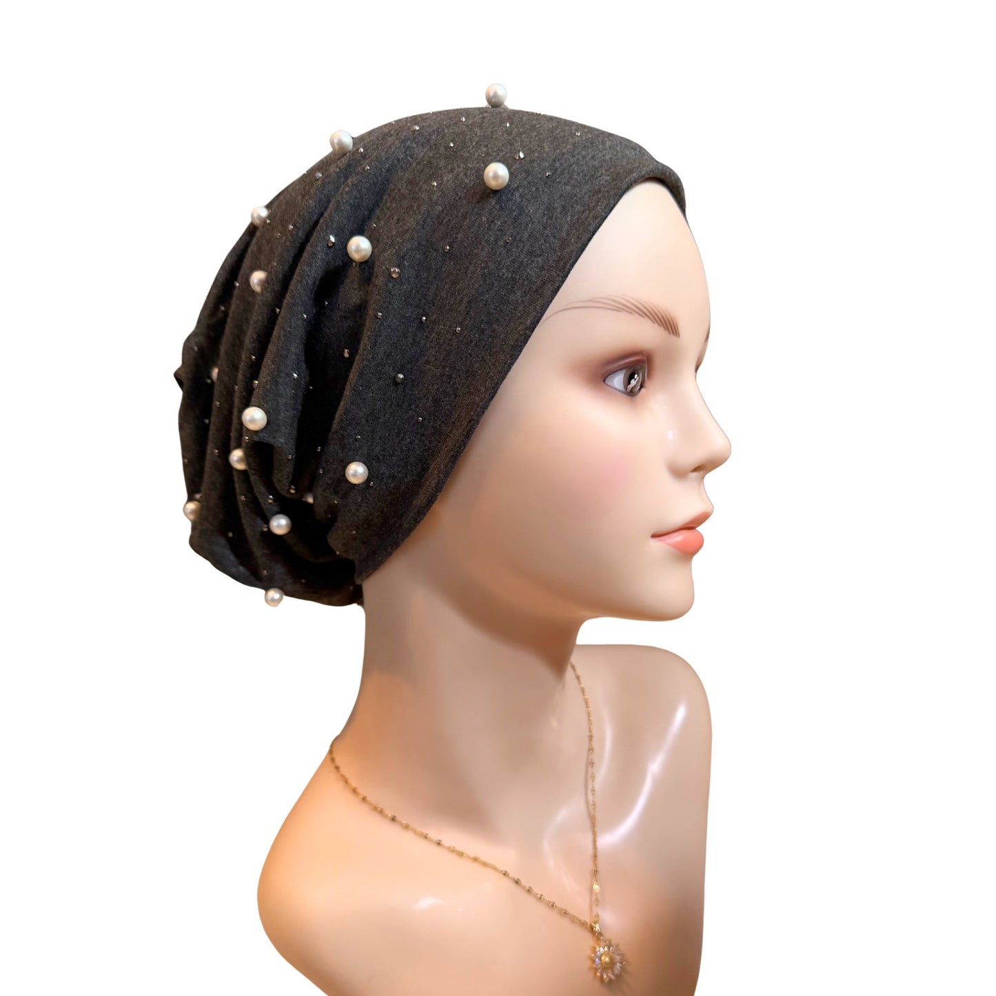 Dark gray hat with pearls on a mannequin head against a white background