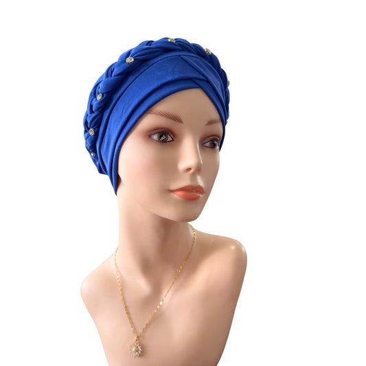 A royal blue knotted headwrap or turban-style headscarf displayed on a mannequin bust, with small decorative bead accents and a gold necklace against a plain white background.