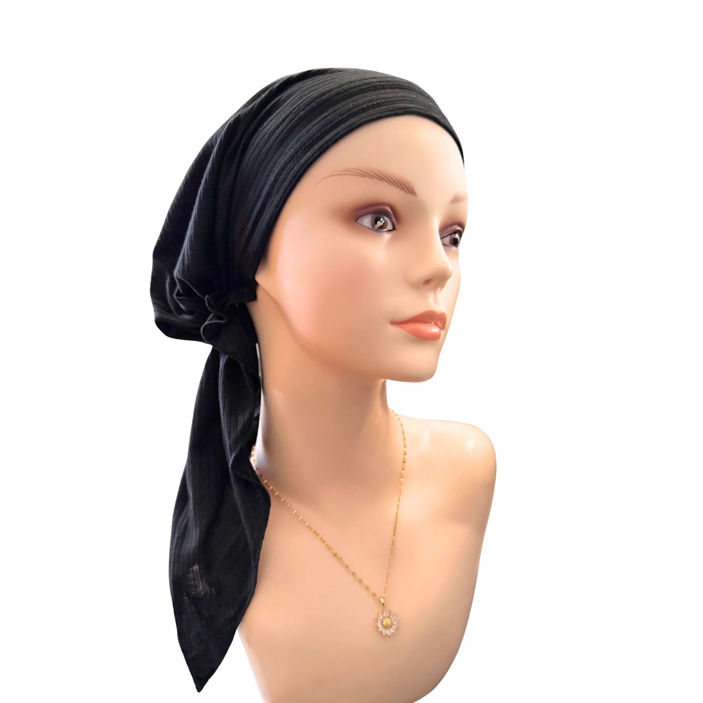 Mannequin head with a black headscarf on a white background