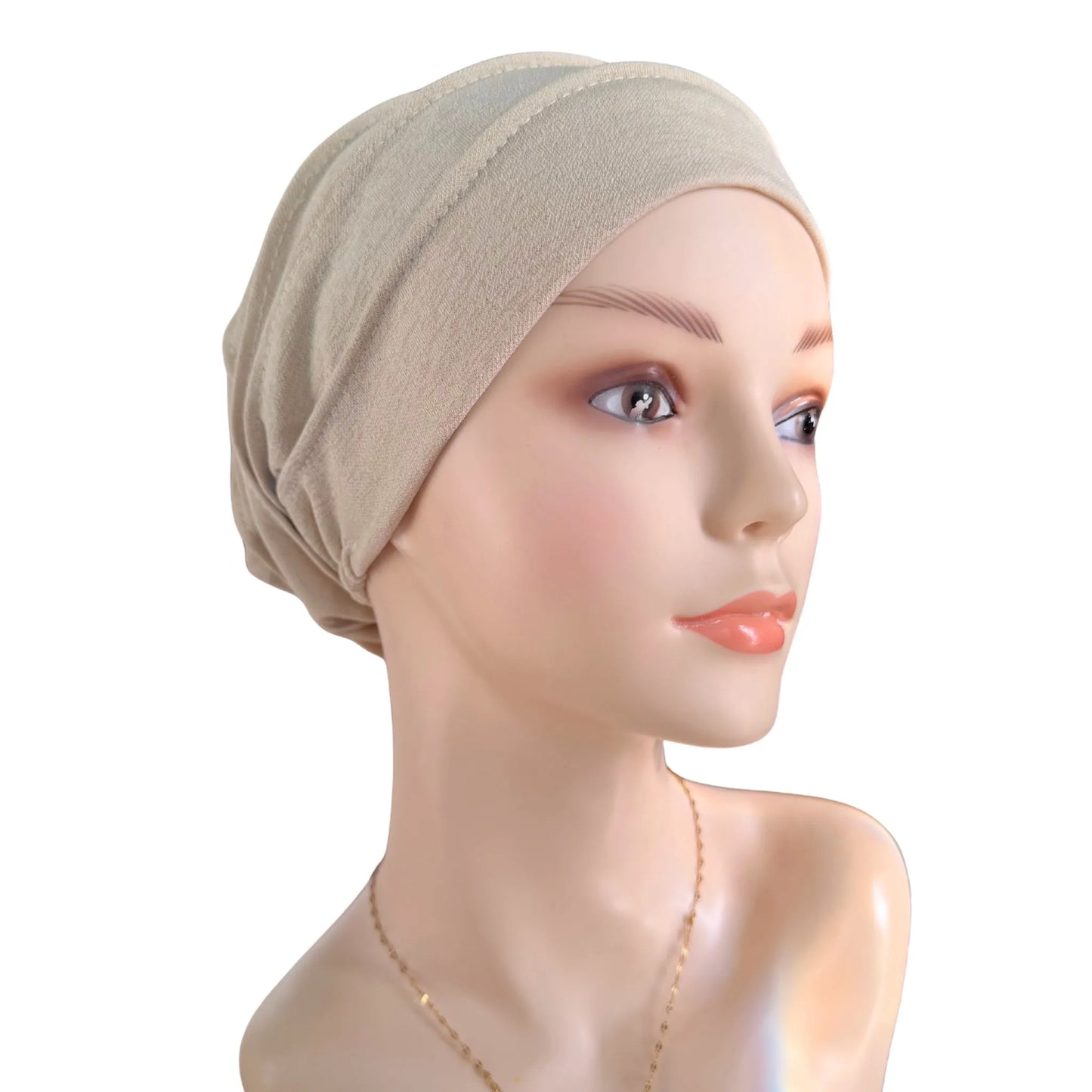 Mannequin head wearing a beige headscarf on a white background