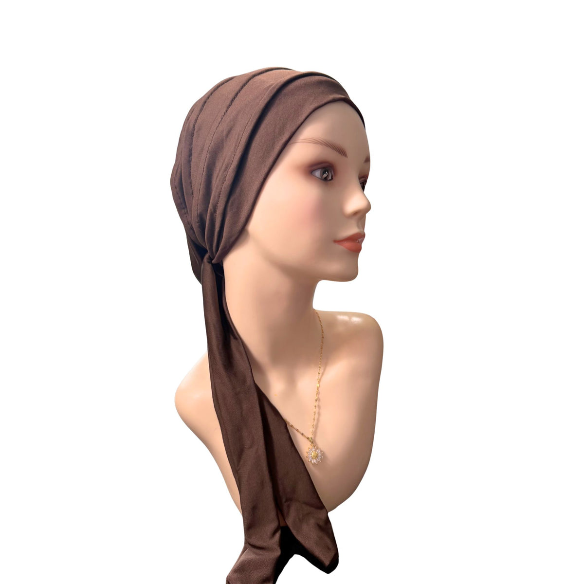 A mannequin bust wearing a dark brown headscarf or turban-style cap, shown in side profile against a plain white background.