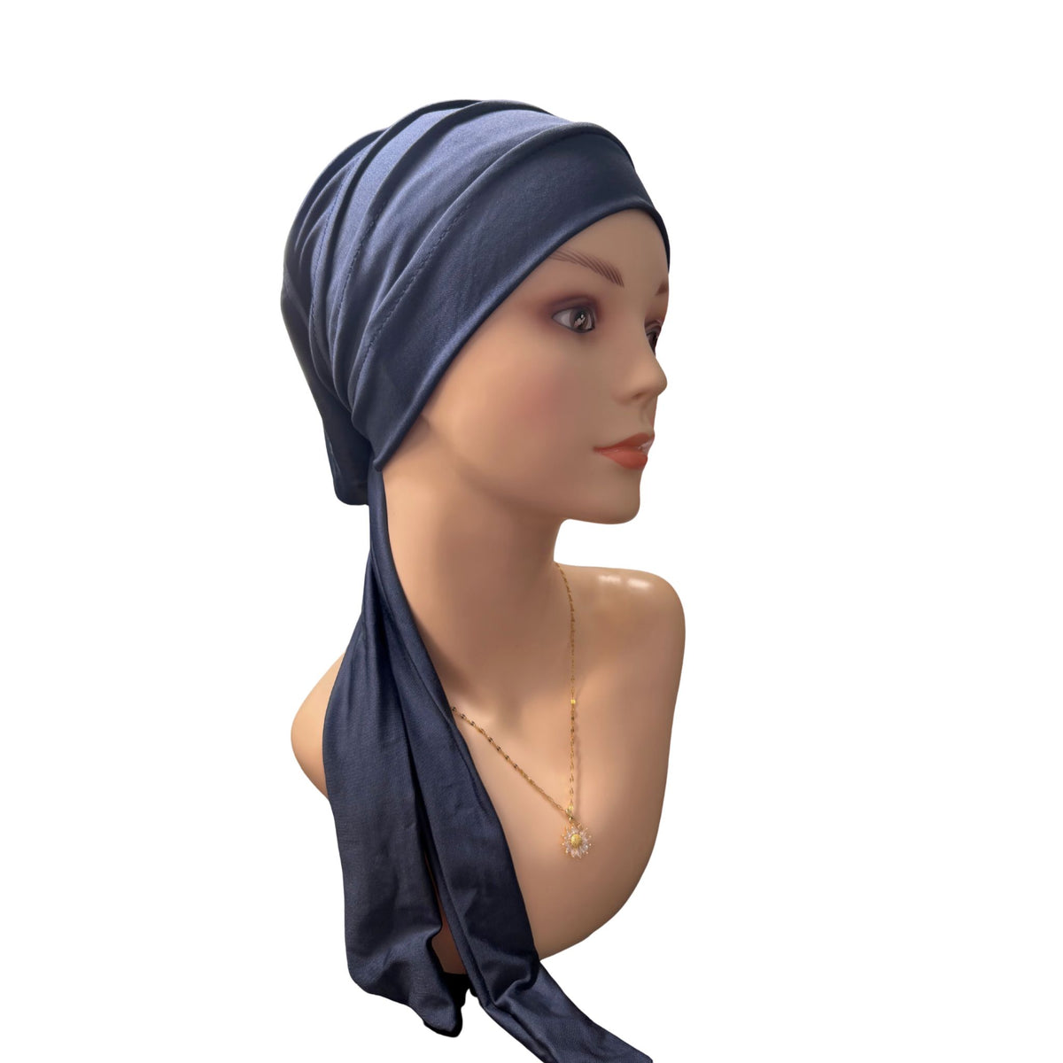 A navy blue fabric headwrap or turban-style headscarf displayed on a mannequin head and shoulders against a plain white background.