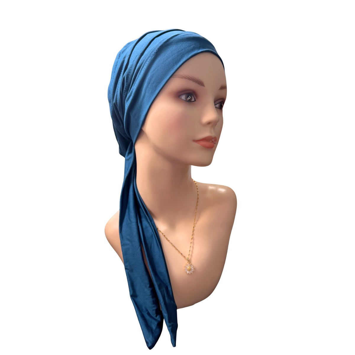 A blue headscarf or turban wrap styled on a mannequin bust against a plain white background.