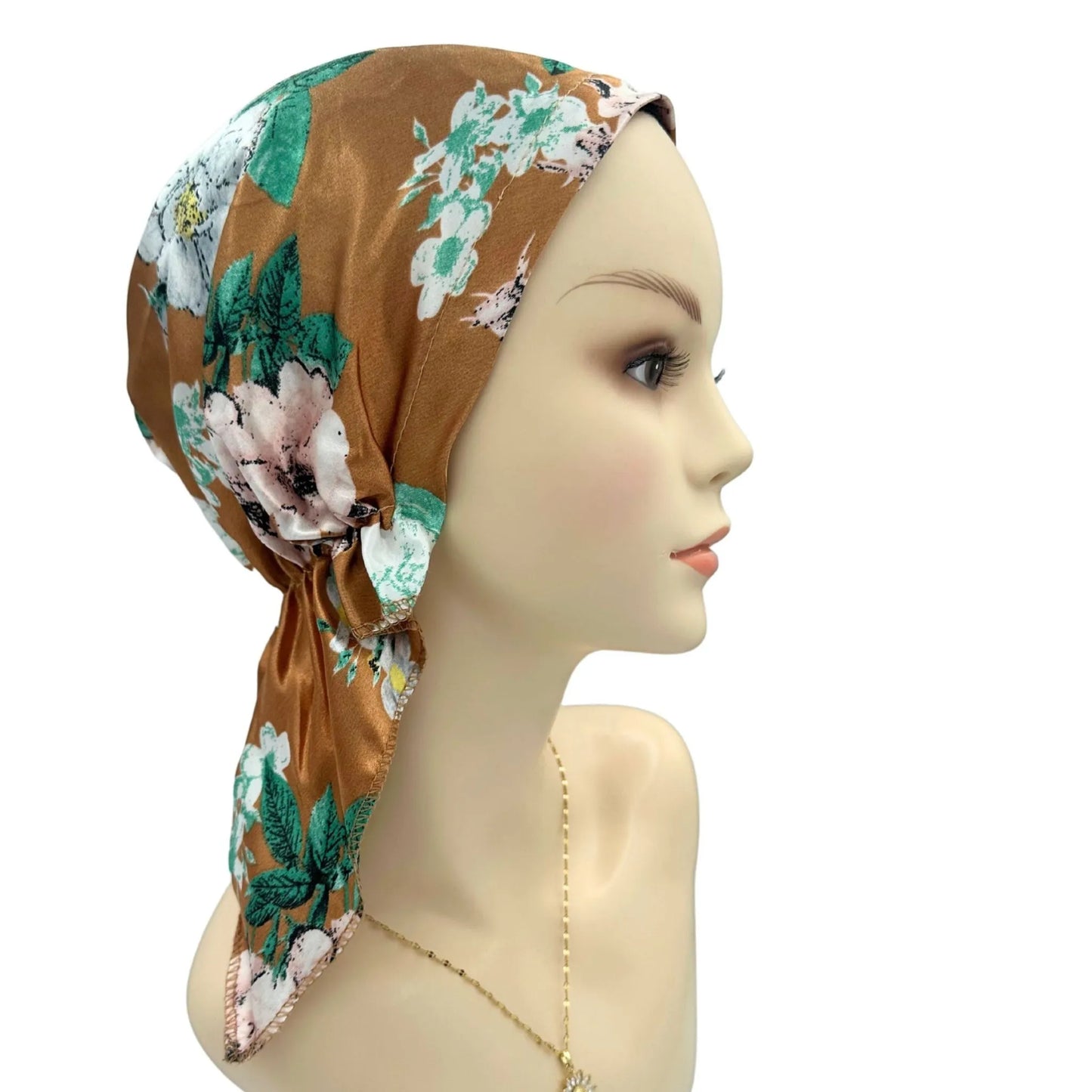 Floral headscarf on a mannequin head against a white background