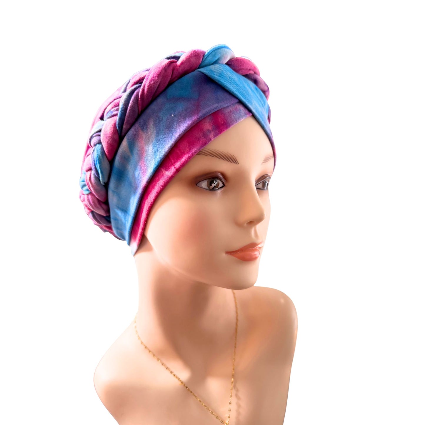 Mannequin head wearing a colorful headscarf on a white background