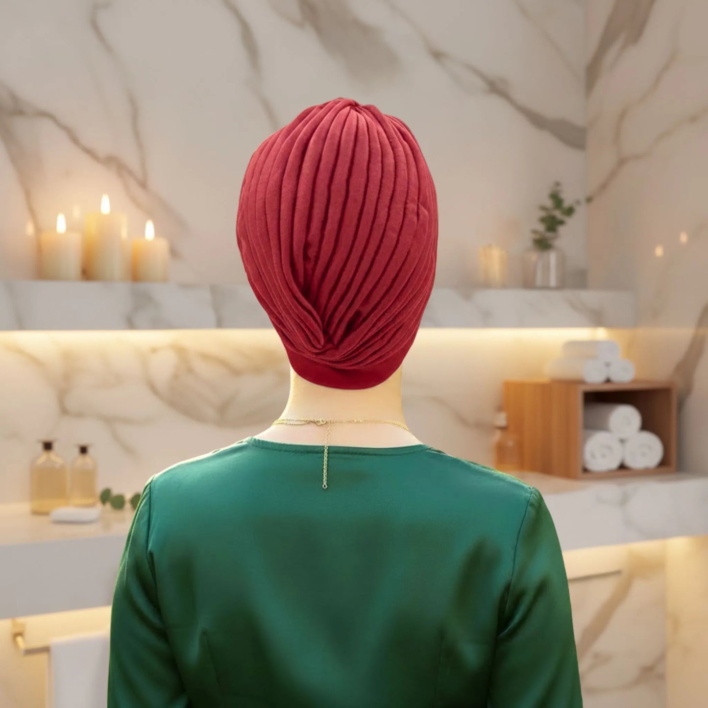 Woman wearing a red floral turban showing the back  in a bathroom setting
